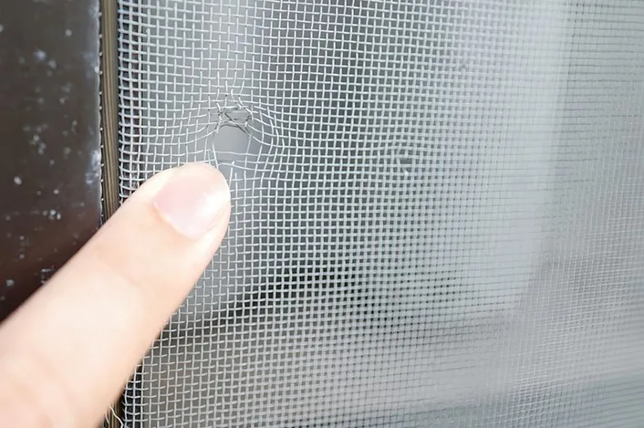 A broken screen window A broken screen window